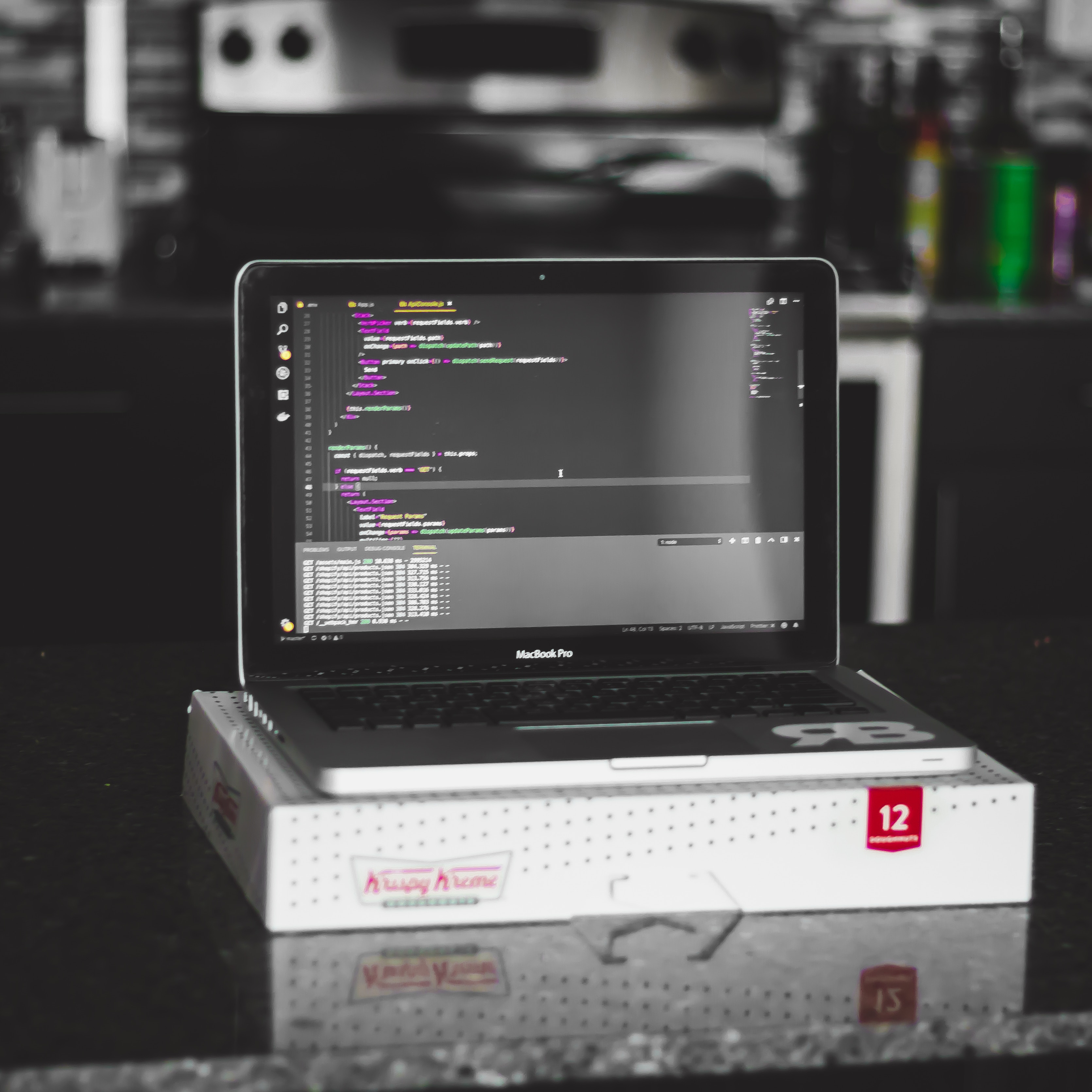 laptop in a krispy kreme with coding screen